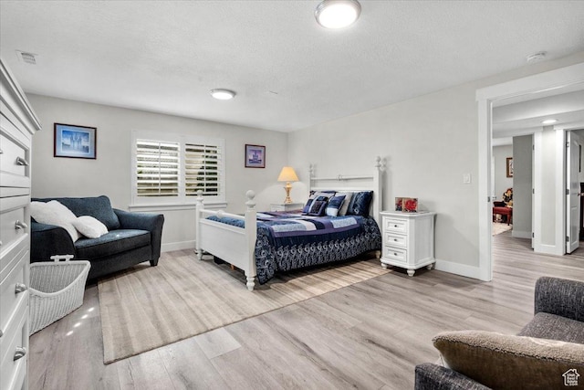 10539 S Haven View Ct W, South Jordan, UT 84095 - bedroom with light wood-style floors, a textured ceiling, and baseboards