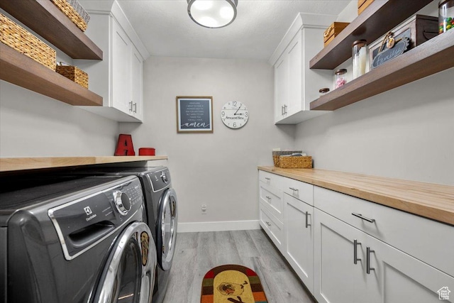 10539 S Haven View Ct W, South Jordan, UT 84095 - washroom with independent washer and dryer, cabinet space, light wood-style flooring, and baseboards