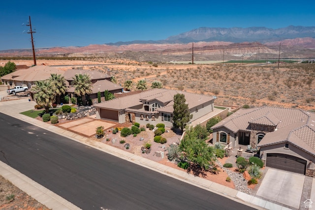 aerial view of property and surrounding area featuring a mountain backdrop