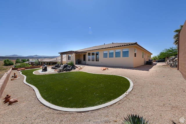 back of house with a patio, a pergola, a tiled roof, stucco siding, and a mountain view