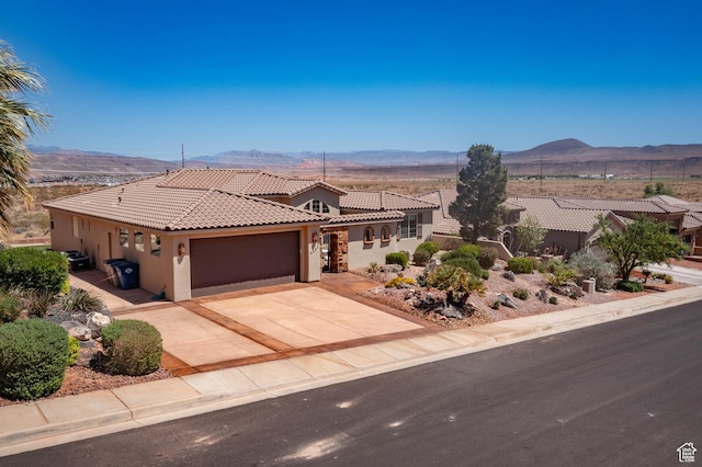 mediterranean / spanish home with stucco siding, a tile roof, and a mountain view