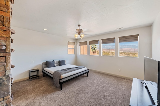 bedroom featuring carpet flooring, baseboards, and a ceiling fan