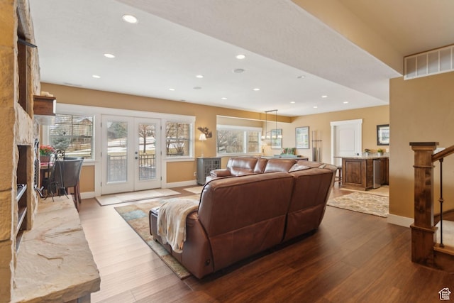 living area featuring baseboards, wood finished floors, recessed lighting, and french doors
