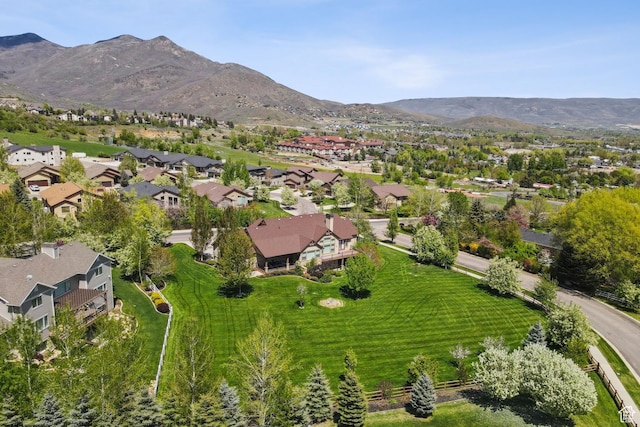 view of property location with a mountainous background and nearby suburban area