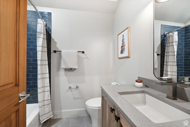 bathroom with toilet, baseboards, vanity, wood finished floors, and shower / bath combo with shower curtain