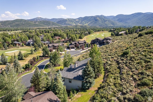 aerial perspective of suburban area featuring a mountain backdrop and a golf club