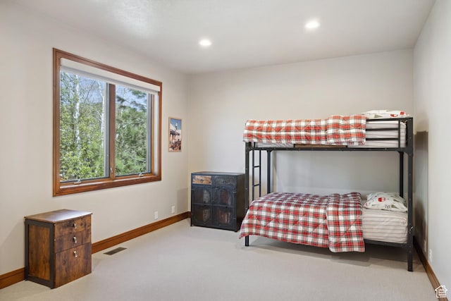 carpeted bedroom featuring baseboards and recessed lighting