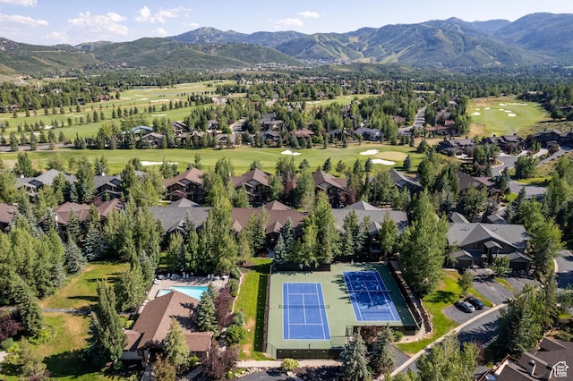 bird's eye view of mountains and a golf club