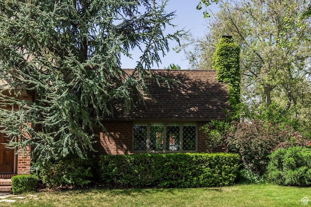 1677 E Yalecrest Ave, Salt Lake City, UT 84105 - view of front of home featuring brick siding, roof with shingles, a front lawn, and a chimney