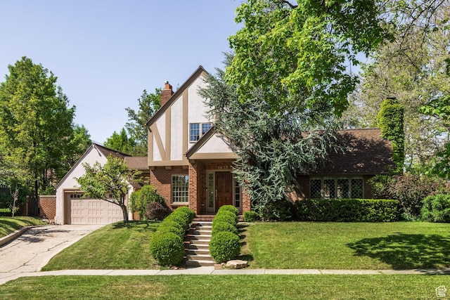 1677 E Yalecrest Ave, Salt Lake City, UT 84105 - tudor house featuring a chimney, concrete driveway, an attached garage, and a front yard