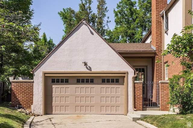 1677 E Yalecrest Ave, Salt Lake City, UT 84105 - view of front of property with stucco siding, an attached garage, concrete driveway, and a shingled roof