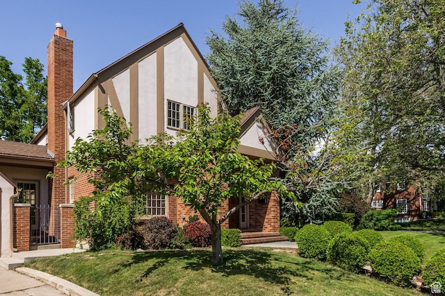 1677 E Yalecrest Ave, Salt Lake City, UT 84105 - english style home featuring a chimney, brick siding, stucco siding, and a front yard