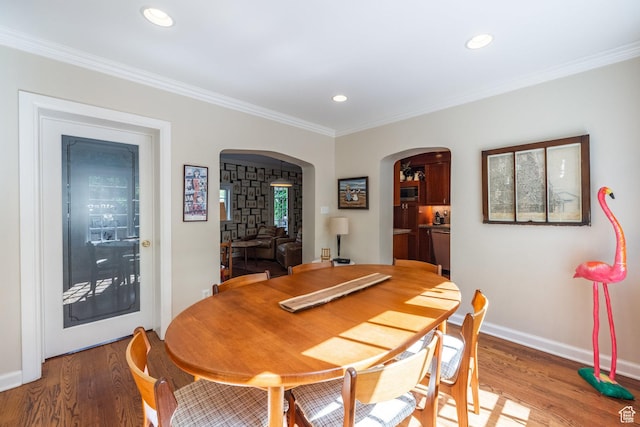 1677 E Yalecrest Ave, Salt Lake City, UT 84105 - dining room with arched walkways, light wood finished floors, baseboards, recessed lighting, and crown molding