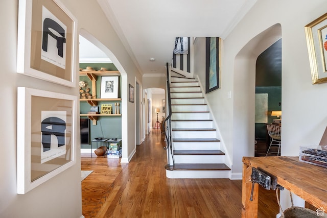 1677 E Yalecrest Ave, Salt Lake City, UT 84105 - stairway featuring arched walkways, ornamental molding, wood finished floors, and baseboards