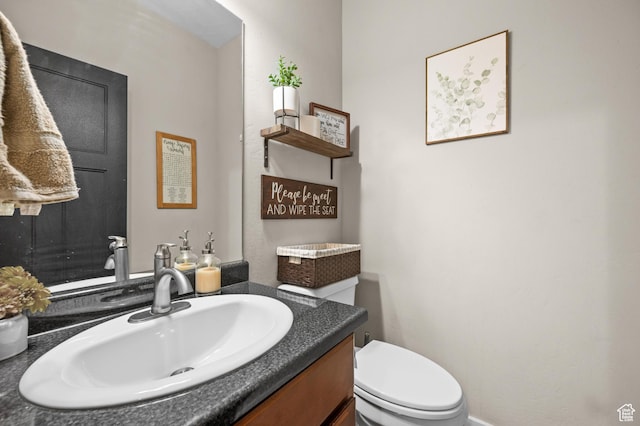bathroom featuring toilet and vanity