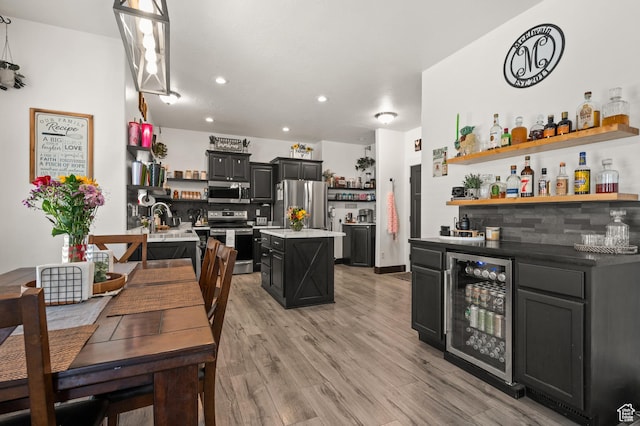 dining area with wine cooler, bar, light wood-type flooring, and recessed lighting