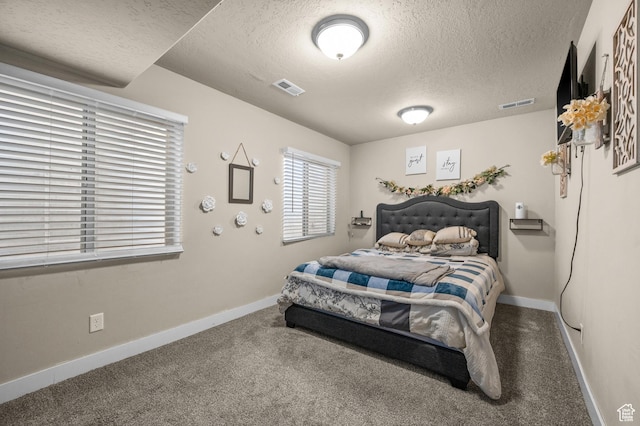 bedroom featuring carpet floors, a textured ceiling, and baseboards