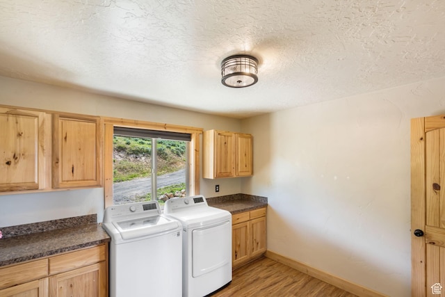 2013 N River View Cir, Huntsville, UT 84317 - laundry area featuring washer and clothes dryer, light wood-style flooring, cabinet space, a textured ceiling, and baseboards