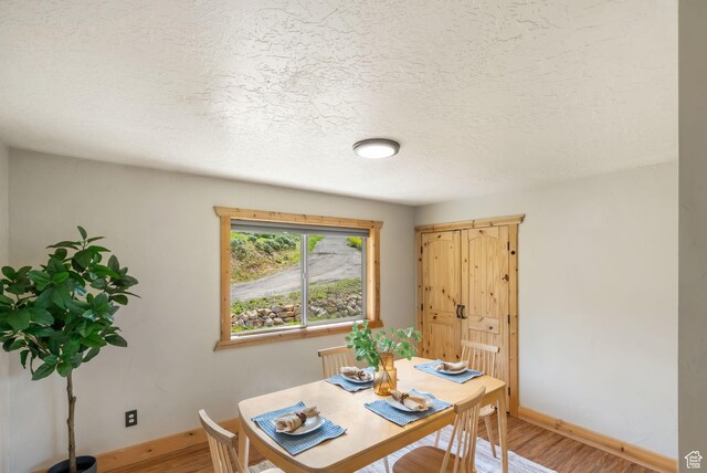 2013 N River View Cir, Huntsville, UT 84317 - dining space with baseboards, light wood-type flooring, and a textured ceiling