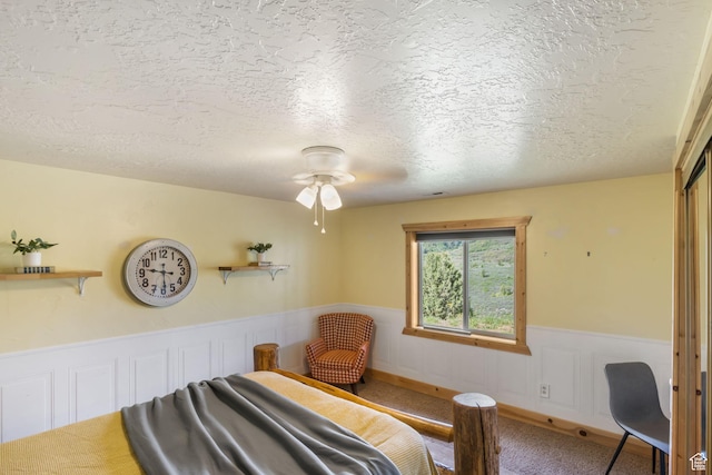 2013 N River View Cir, Huntsville, UT 84317 - bedroom with a textured ceiling, carpet, wainscoting, and ceiling fan