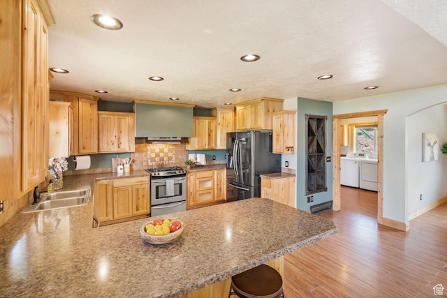 2013 N River View Cir, Huntsville, UT 84317 - kitchen featuring stainless steel appliances, separate washer and dryer, a peninsula, a sink, and light brown cabinetry