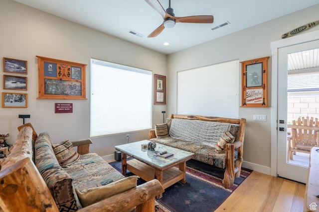 living area featuring ceiling fan, wood finished floors, baseboards, healthy amount of natural light, and recessed lighting