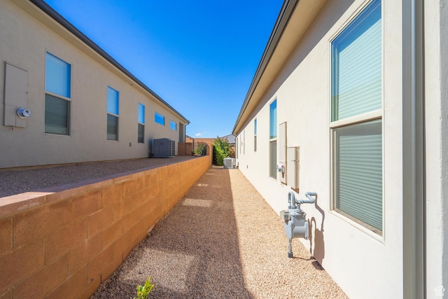 view of property exterior with stucco siding and cooling unit