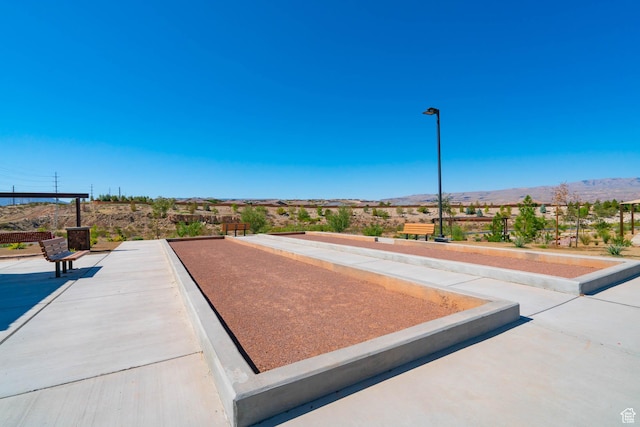 view of property's community with a bocce ball area and a mountain view