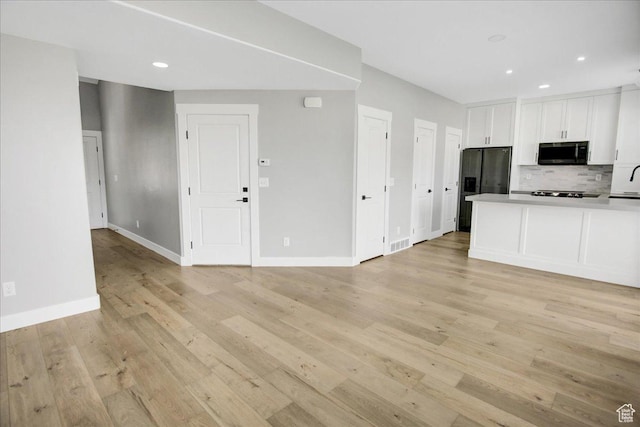 91 E 8000 S, Midvale, UT 84070 - kitchen with black appliances, white cabinets, light wood-type flooring, tasteful backsplash, and recessed lighting