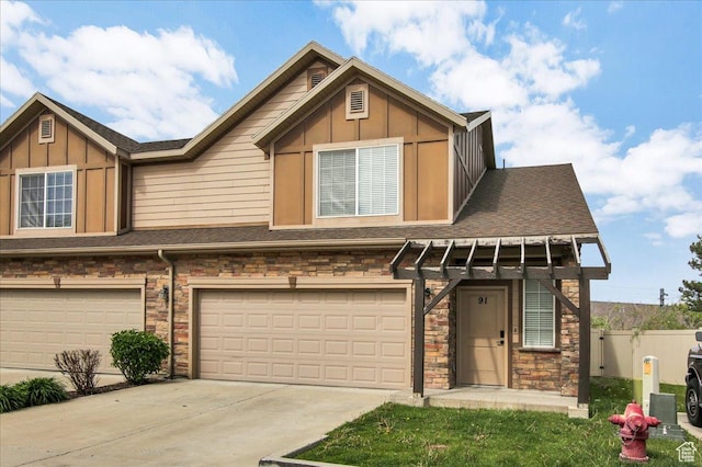 91 E 8000 S, Midvale, UT 84070 - view of property with stone siding, an attached garage, driveway, and board and batten siding