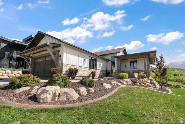 732 S Nebo Cir, Woodland Hills, UT 84653 - view of front of home with stone siding, an attached garage, and a front lawn