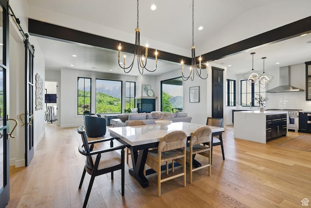 732 S Nebo Cir, Woodland Hills, UT 84653 - dining room with a chandelier, recessed lighting, light wood-style floors, a barn door, and lofted ceiling