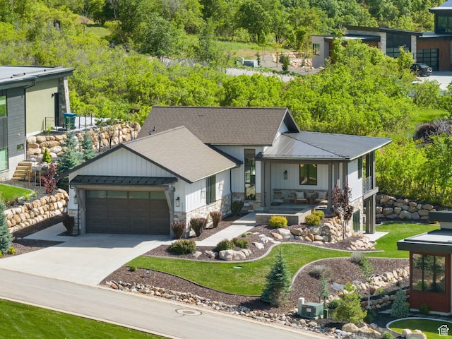 732 S Nebo Cir, Woodland Hills, UT 84653 - view of front of property featuring board and batten siding, an attached garage, concrete driveway, a standing seam roof, and metal roof