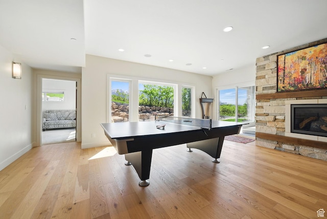 732 S Nebo Cir, Woodland Hills, UT 84653 - recreation room with light wood-style flooring, a stone fireplace, baseboards, and recessed lighting