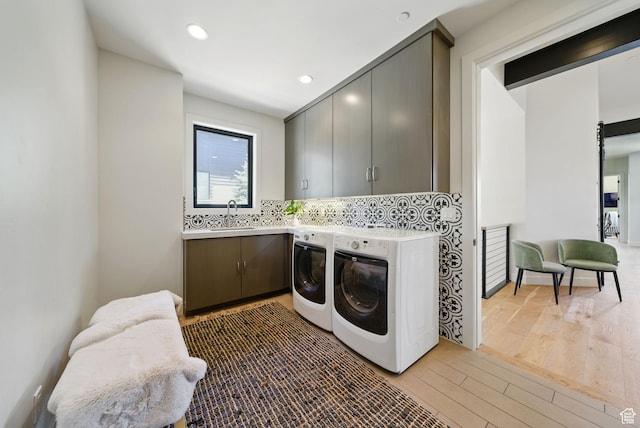 732 S Nebo Cir, Woodland Hills, UT 84653 - clothes washing area with cabinet space, washer and clothes dryer, light wood-style flooring, and recessed lighting