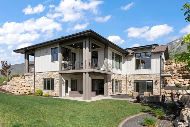 732 S Nebo Cir, Woodland Hills, UT 84653 - back of property featuring a balcony, stone siding, a patio, a yard, and a mountain view