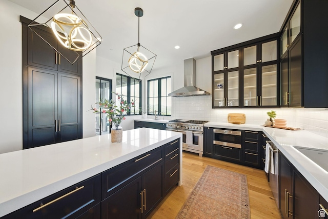 732 S Nebo Cir, Woodland Hills, UT 84653 - kitchen featuring wall chimney range hood, appliances with stainless steel finishes, light countertops, backsplash, and recessed lighting