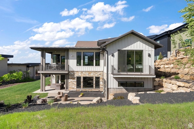 732 S Nebo Cir, Woodland Hills, UT 84653 - back of house with a balcony, board and batten siding, a patio, a yard, and stone siding