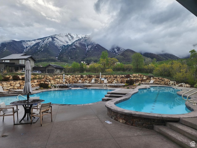 732 S Nebo Cir, Woodland Hills, UT 84653 - community pool featuring a mountain view and a patio