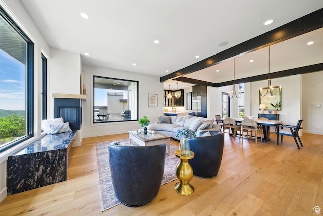 732 S Nebo Cir, Woodland Hills, UT 84653 - living area with a chandelier, light wood-type flooring, recessed lighting, baseboards, and a glass covered fireplace