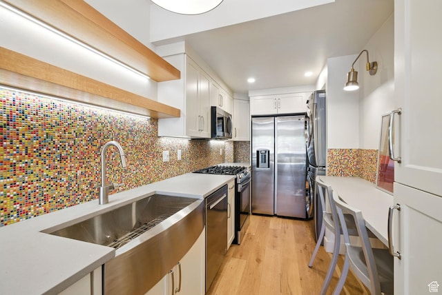 732 S Nebo Cir, Woodland Hills, UT 84653 - kitchen with stainless steel appliances, open shelves, white cabinetry, light wood finished floors, and light countertops