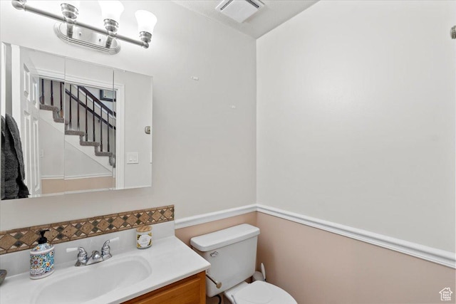 bathroom featuring toilet and vanity