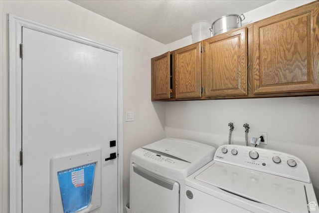 washroom featuring cabinet space and washer and dryer