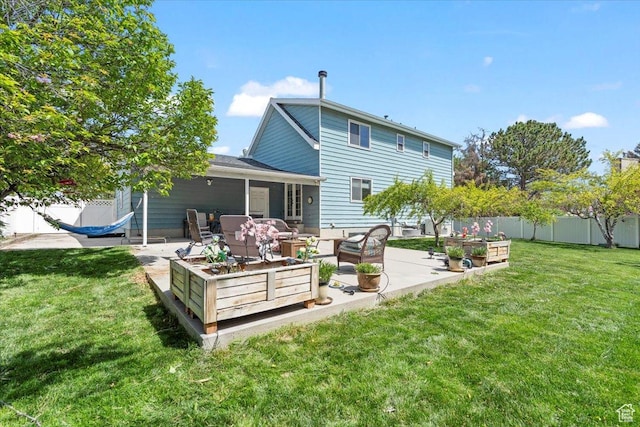 rear view of house with an outdoor hangout area, a patio, and a garden