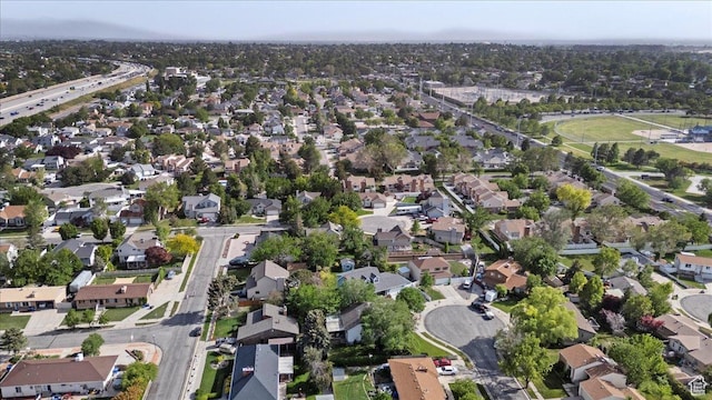 aerial view of property and surrounding area with nearby suburban area