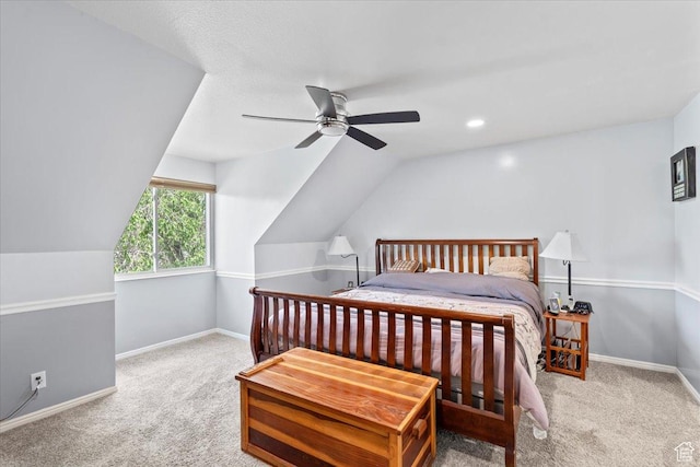carpeted bedroom with lofted ceiling, baseboards, and a ceiling fan