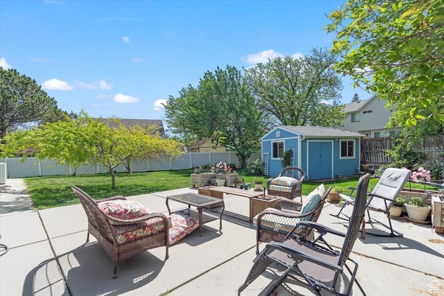view of patio with outdoor lounge area, a shed, and an outbuilding