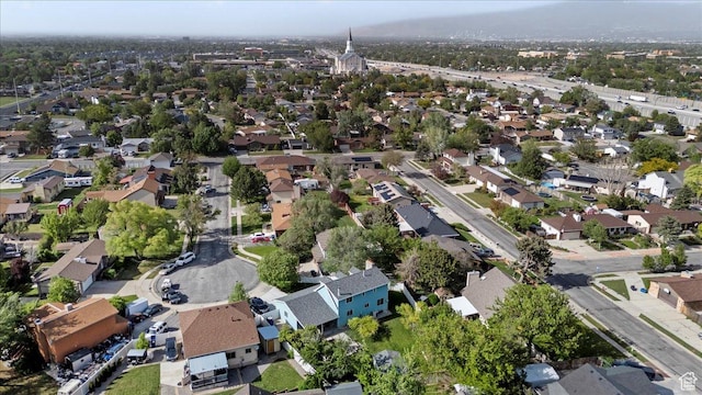 aerial view of property and surrounding area with nearby suburban area