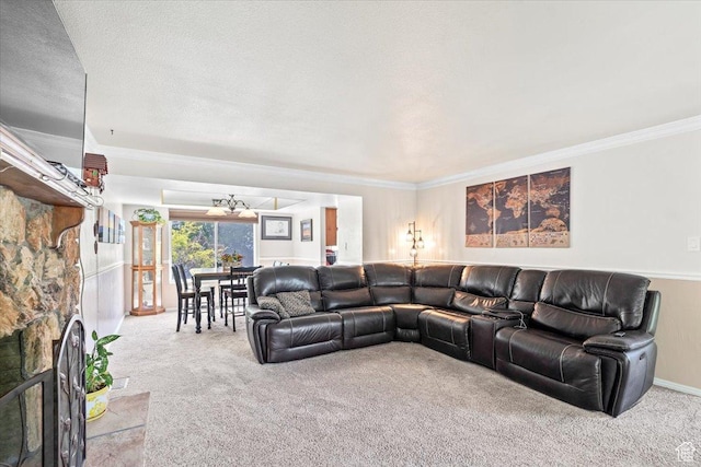 living area with carpet floors, a chandelier, ornamental molding, and a textured ceiling