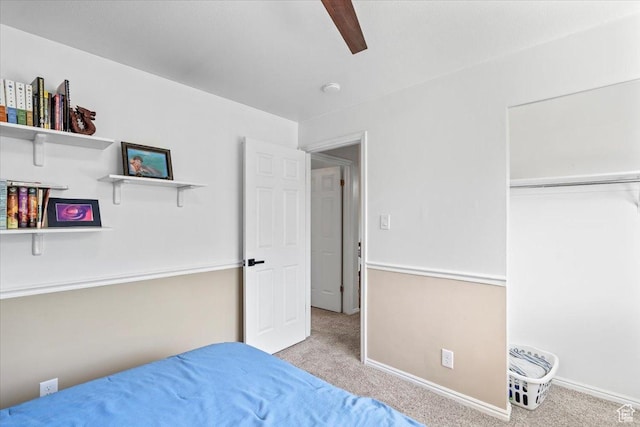 carpeted bedroom with baseboards, a ceiling fan, and a closet